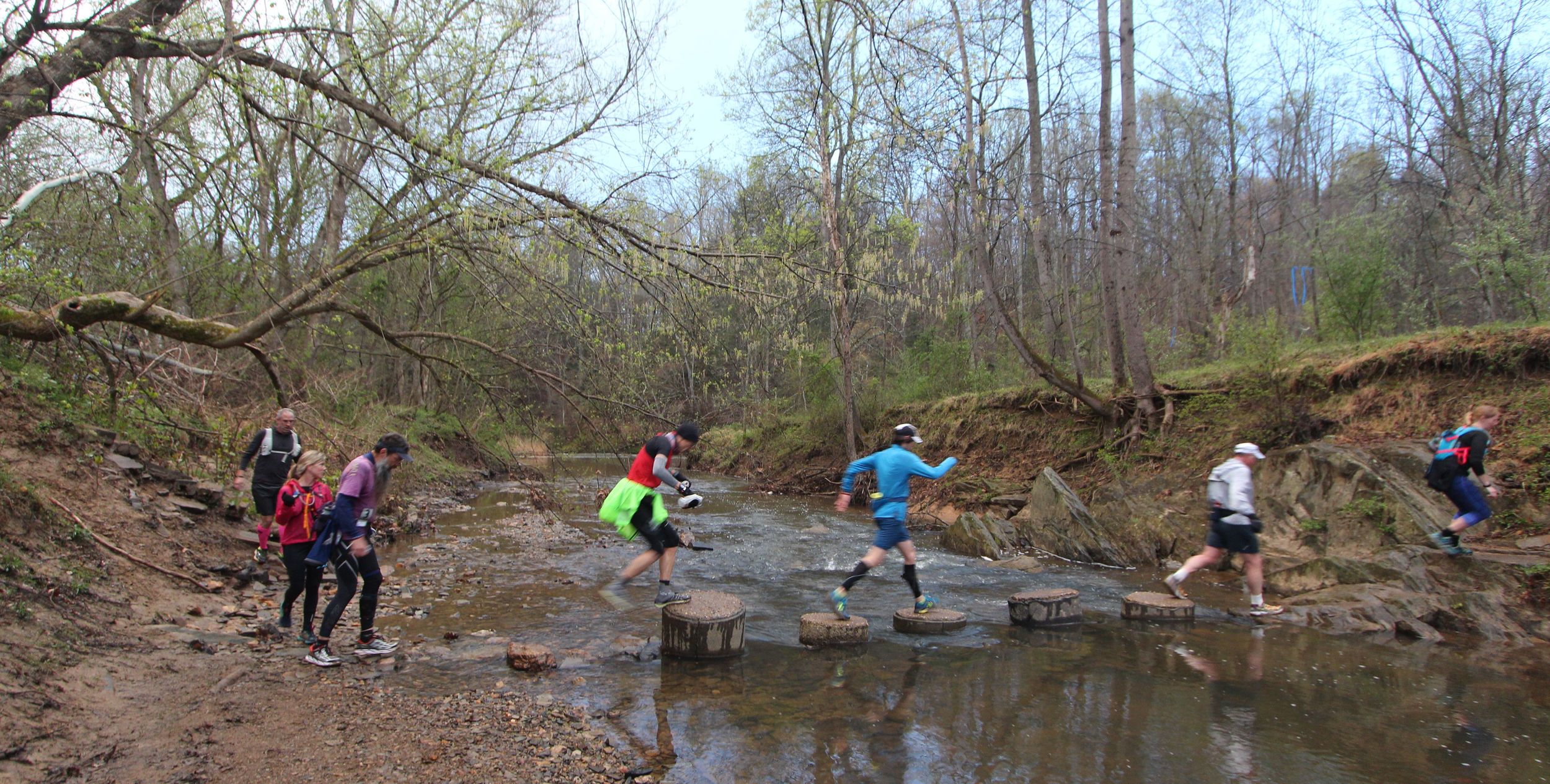 Runners cross Popes Head Creek in the early miles of the 2016 Bull Run Run 50