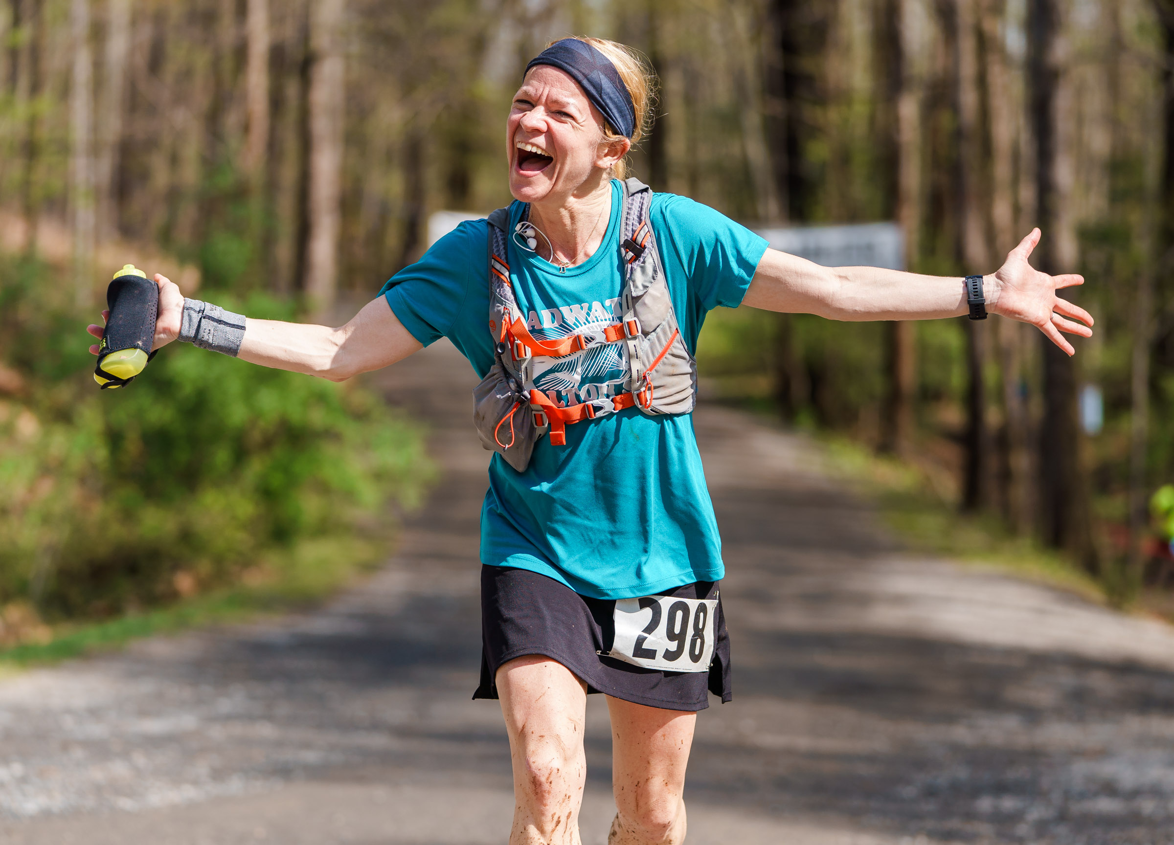 Emily Ryan is all smiles coming back through Hemlock at mile 17.6.